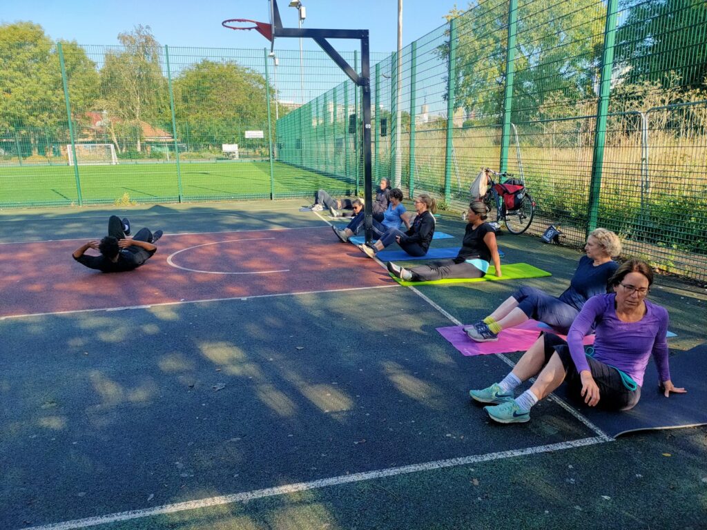 SWBW members working through a mat circuit on an outdoor court