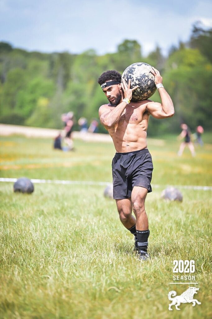 SWBW member carrying an atlas stone during a strength training session