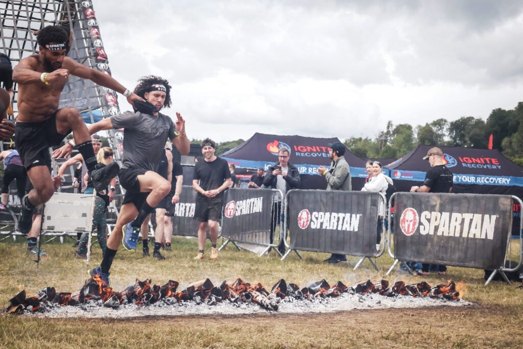 SWBW member clearing the fire jump during a cardio and HIIT session