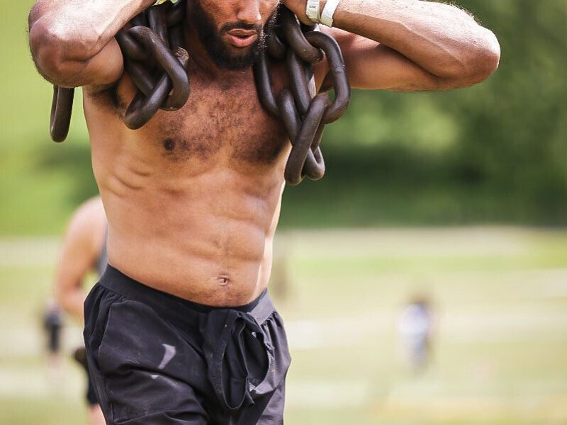 Chain carry strength test SWBW member carrying heavy chains across a field